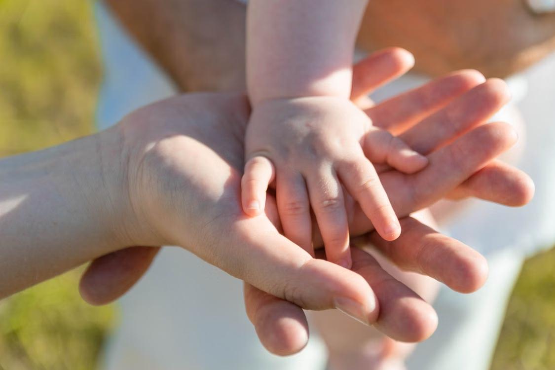 Parent and child hands, from the Khaleej Times estate planning article